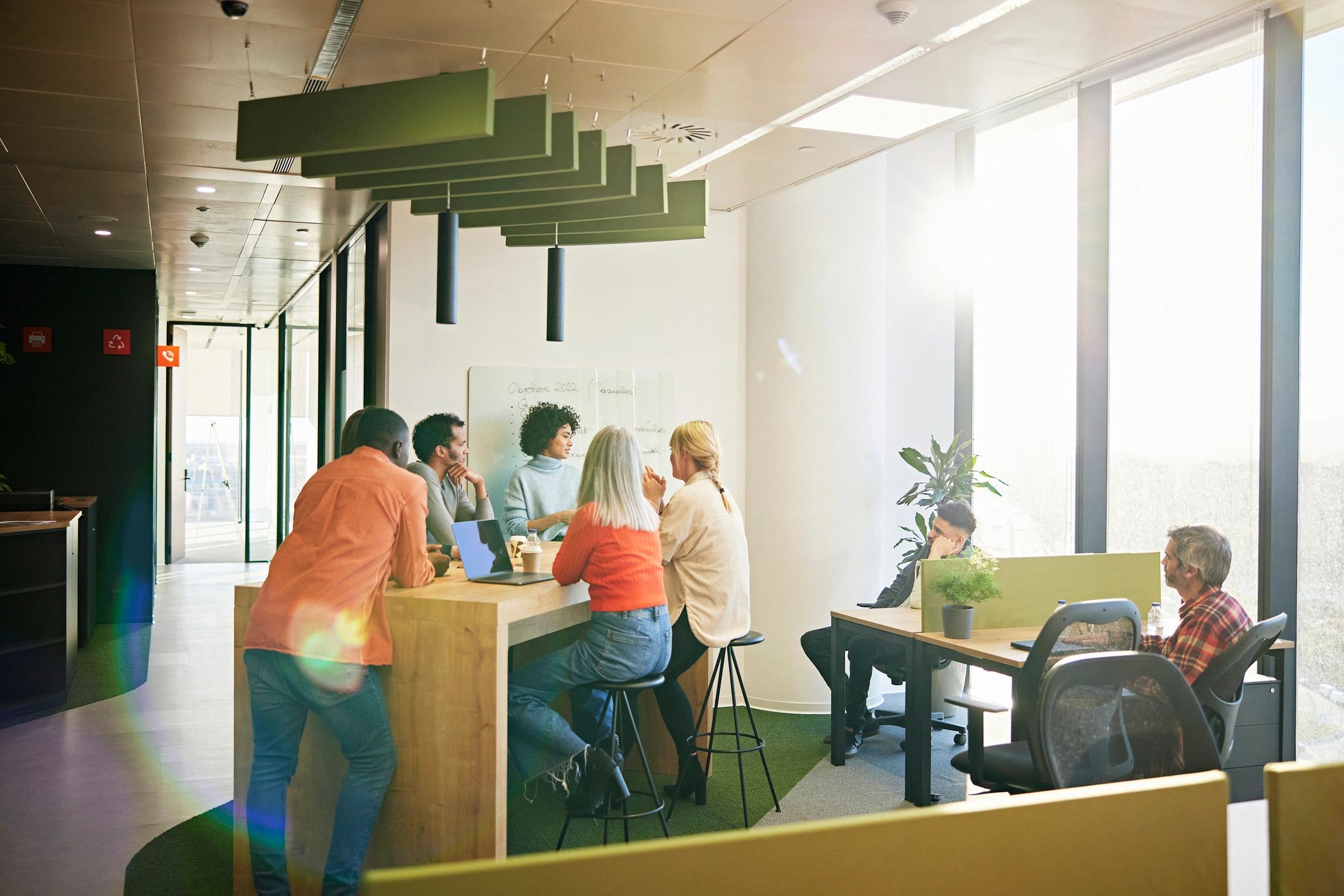 Operations team in an open-plan office aligned on service delivery